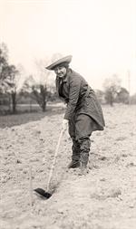 Woman Hoeing Garden