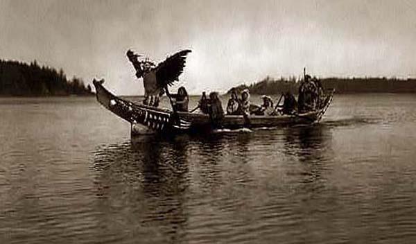 In the bow qunhulahl, a masked man personating the thunderbird, dances as others row to the shores of the bride's village.