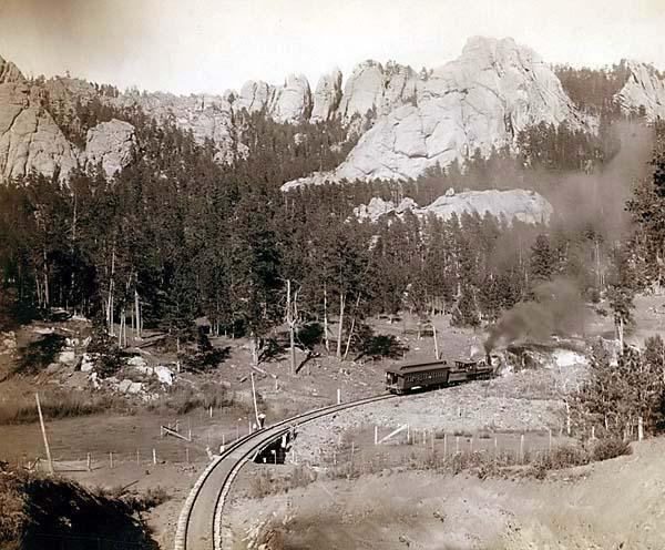 Train Steaming Through Mountains